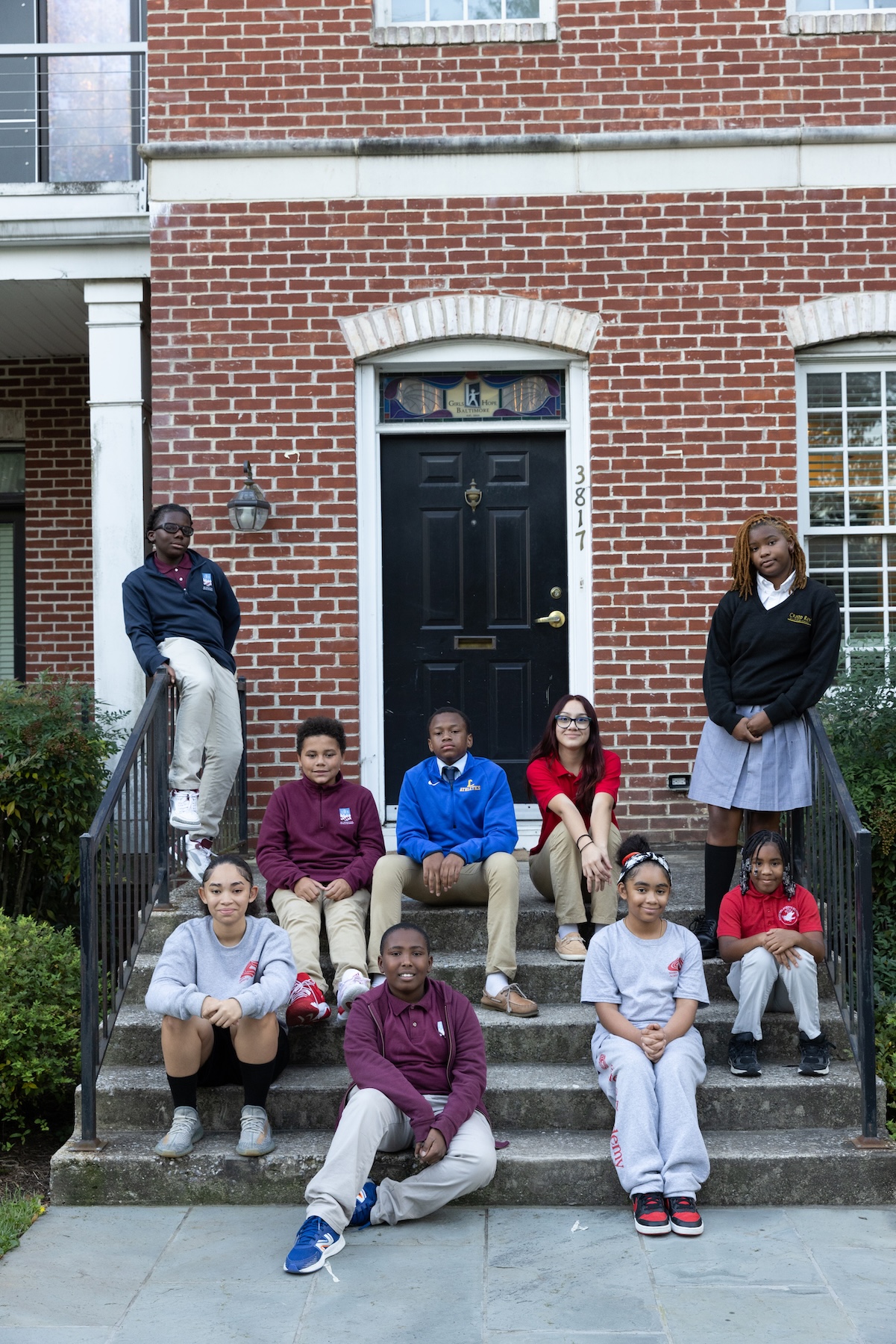 Scholar group on front steps after school in uniforms